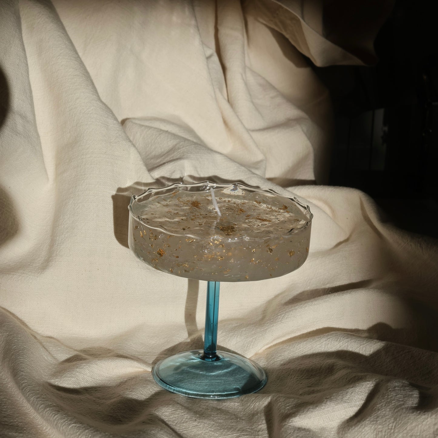 Artistic gel candle in a vintage cocktail glass with golden flakes by Lily Glow Decor