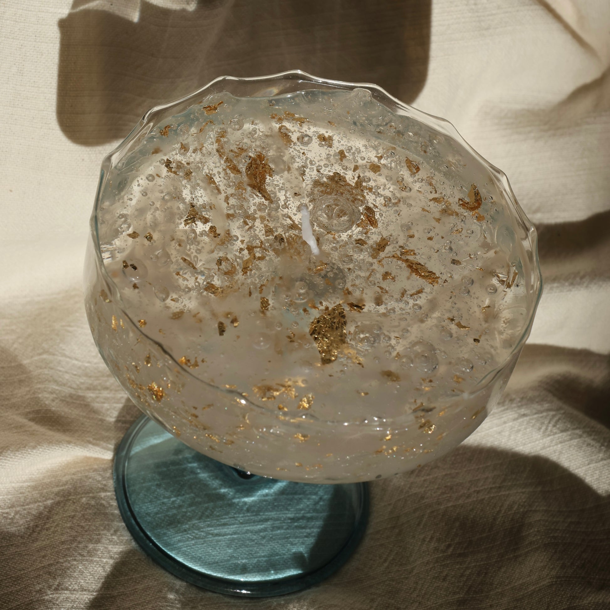 Artistic gel candle in a vintage cocktail glass with golden flakes by Lily Glow Decor