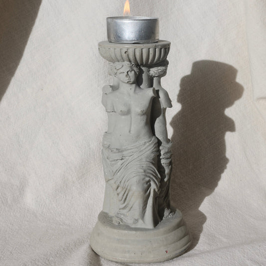 Concrete candle holder with three Venus by Lily Glow Decor figures and a tealight candle
