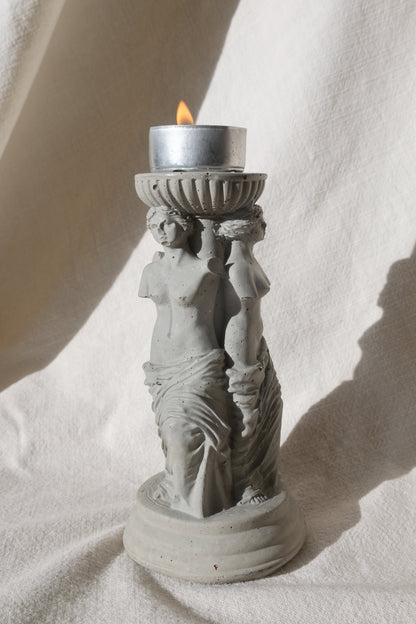 Concrete candle holder with three Venus by Lily Glow Decor figures and a tealight candle