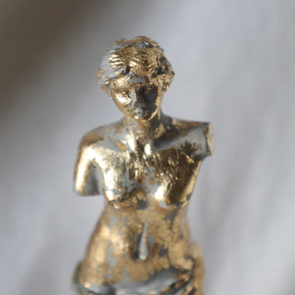 Gold Venus sculpture by Lily Glow Decor with antique finish on soft fabric background