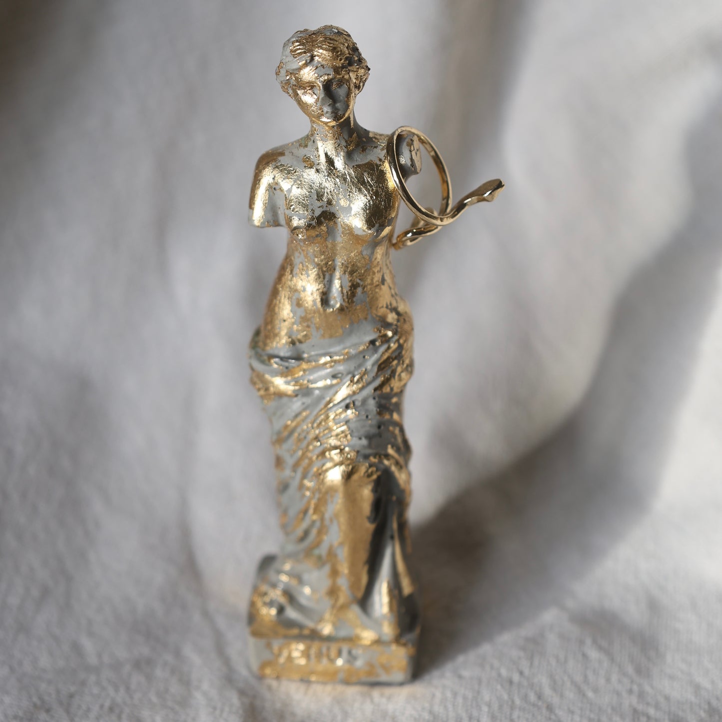 Gold Venus sculpture by Lily Glow Decor with antique finish on soft fabric background