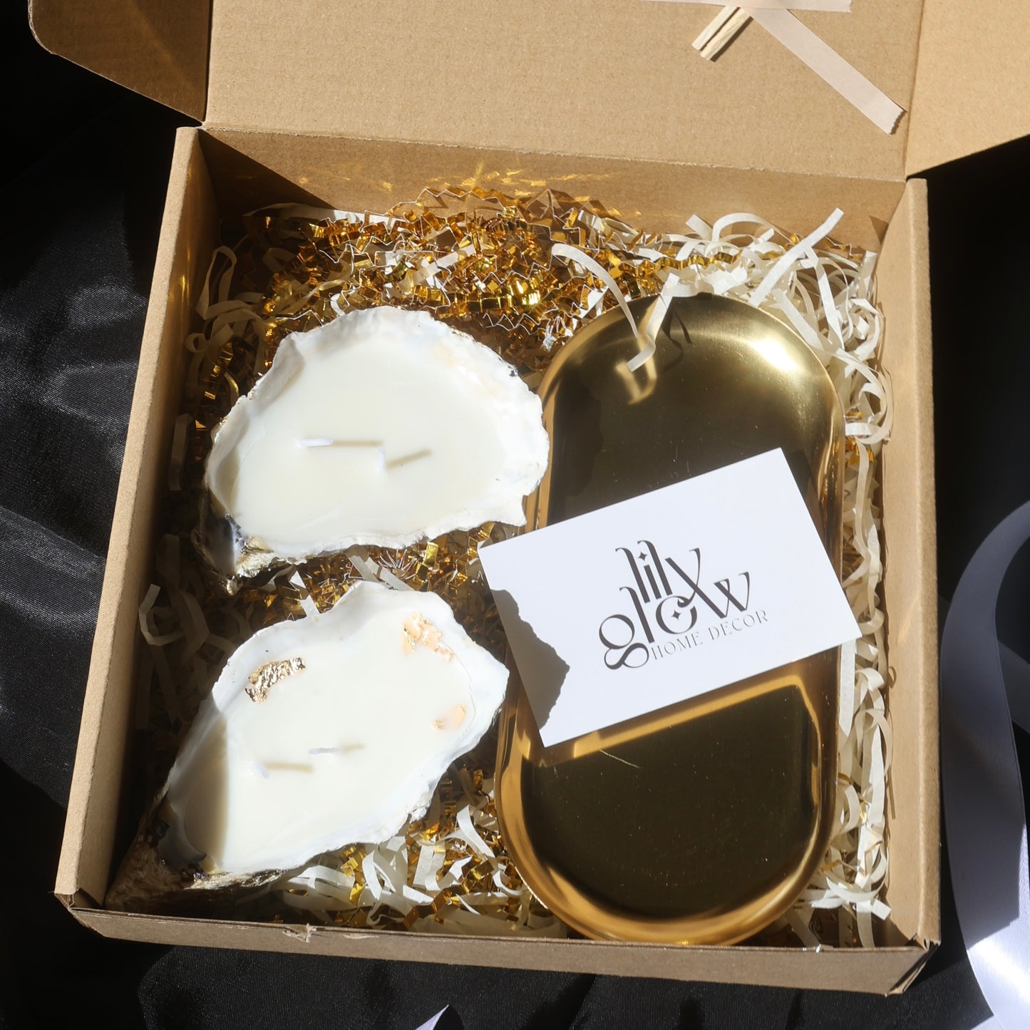 Gift box with two seashell candles and a golden candleholder from Lily Glow Decor