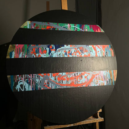 Round abstract painting with colorful splashes and black stripes by Lily Glow Decor