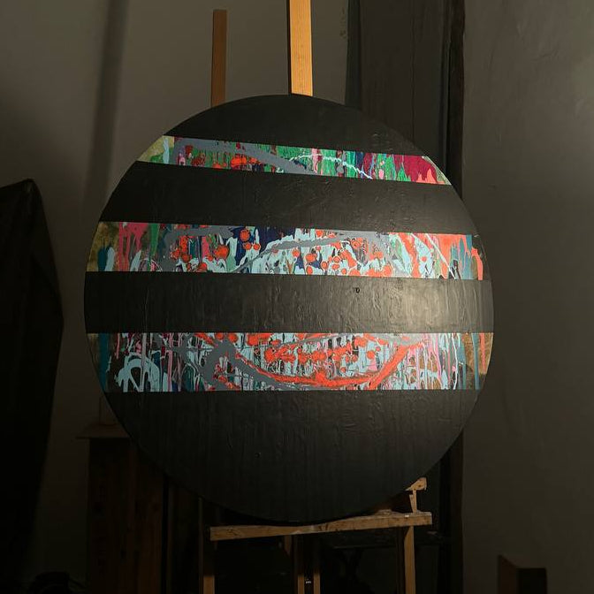 Round abstract painting with colorful splashes and black stripes by Lily Glow Decor