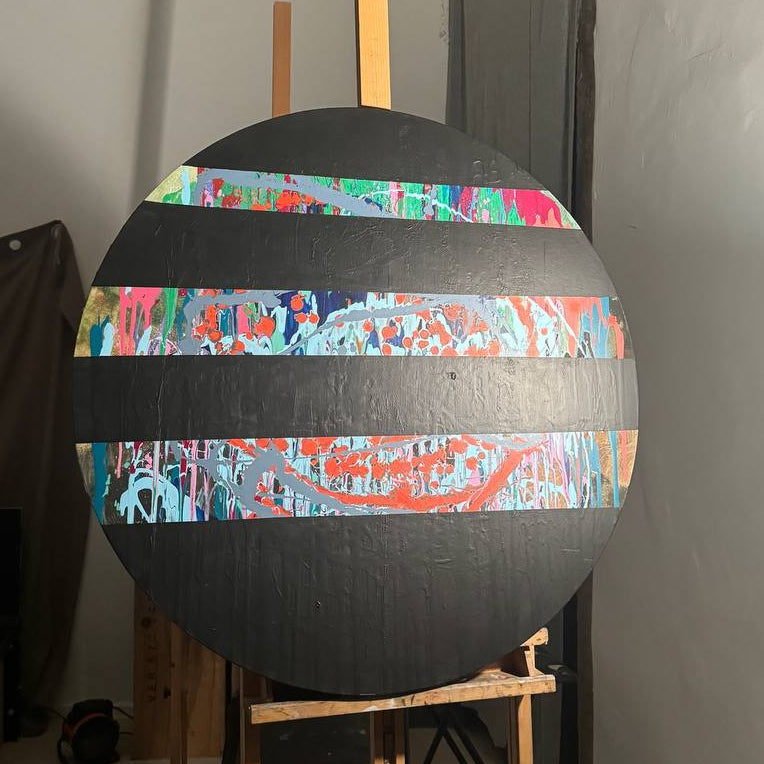 Round abstract painting with colorful splashes and black stripes by Lily Glow Decor