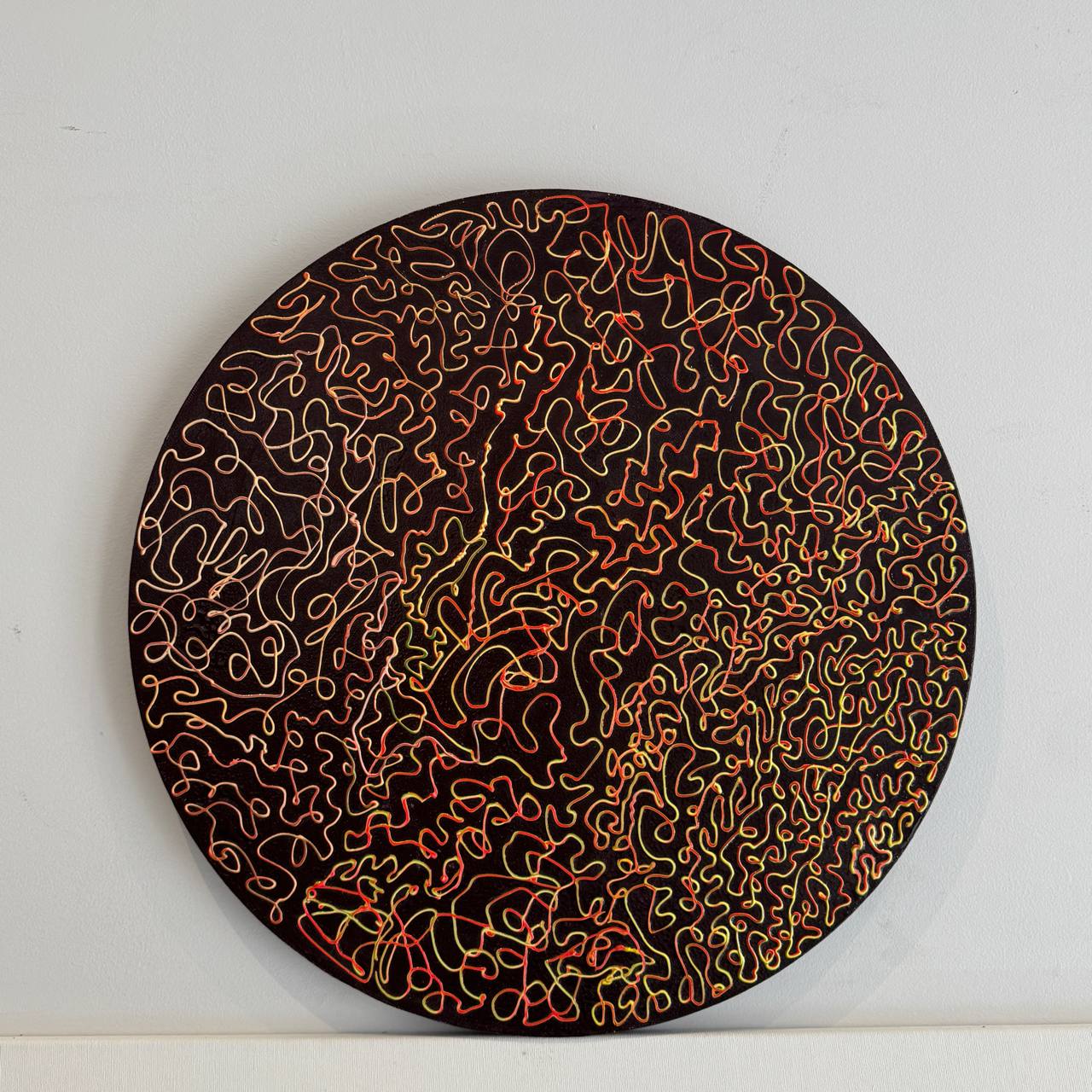 Round abstract painting with red and orange lines on dark background – Lily Glow Decor