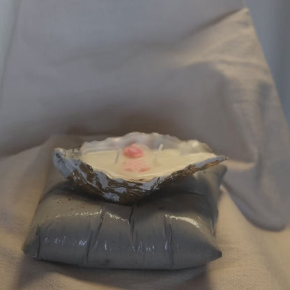 Concrete pillow-shaped candleholder with a glossy finish for displaying a seashell candle by Lily Glow Decor