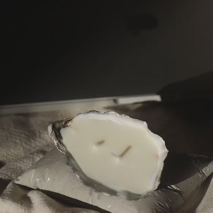 Concrete pillow-shaped candleholder with a glossy finish for displaying a seashell candle by Lily Glow Decor