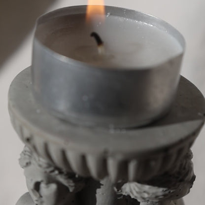 Concrete candle holder with three Venus by Lily Glow Decor figures and a tealight candle