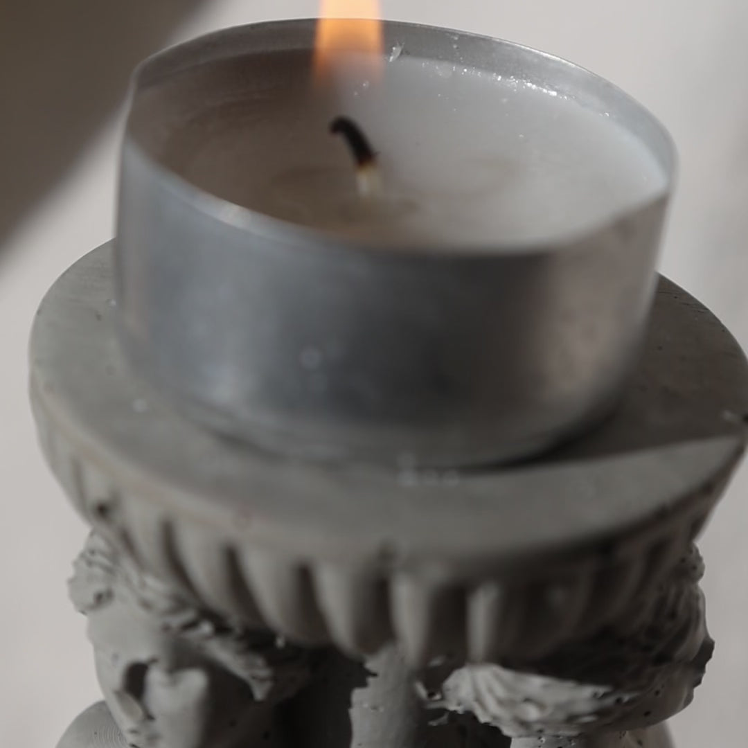 Concrete candle holder with three Venus by Lily Glow Decor figures and a tealight candle