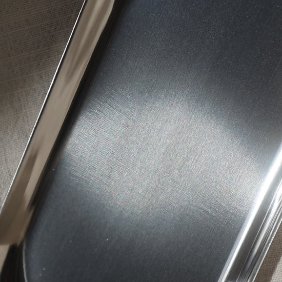 Close-up of silver candleholder by Lily Glow Decor surface texture