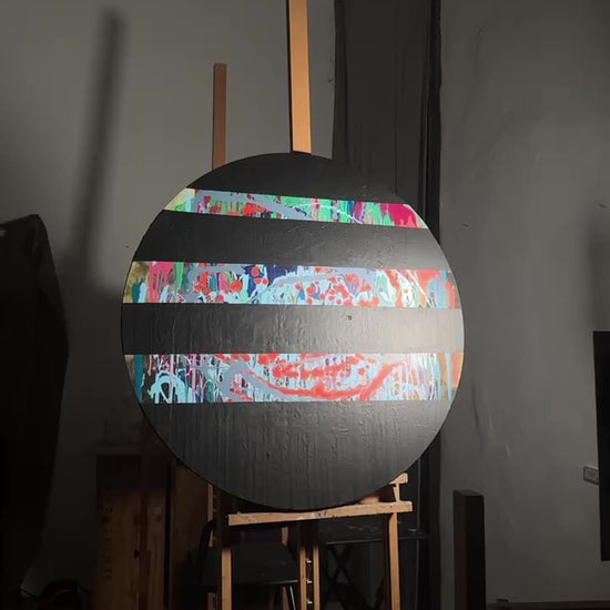 Round abstract painting with colorful splashes and black stripes by Lily Glow Decor