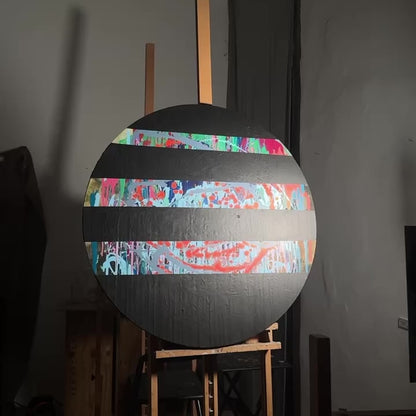 Round abstract painting with colorful splashes and black stripes by Lily Glow Decor